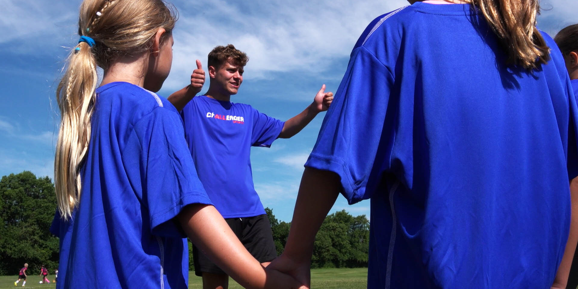 Coach giving campers a thumbs up on camp
