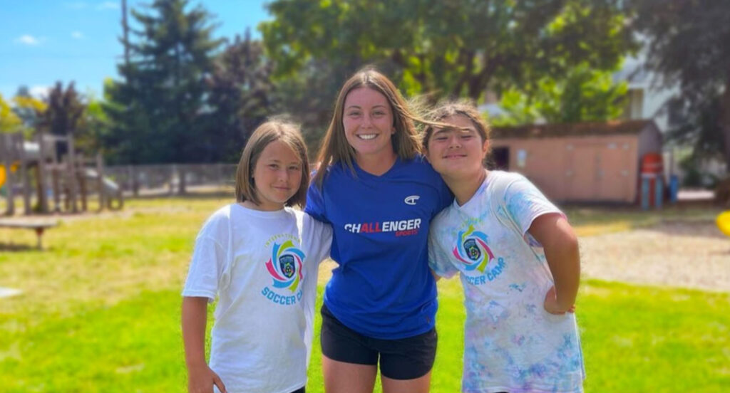 Young Soccer Players Posing with a Challenger Sports Coach