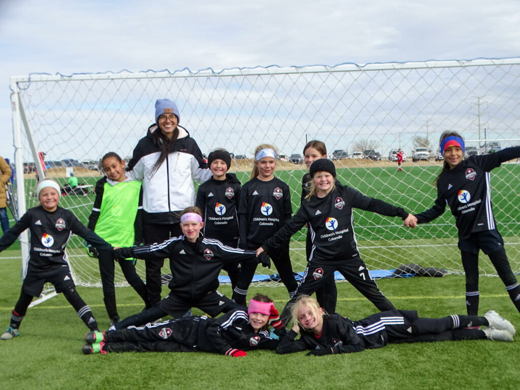 Players posing with coach on camp