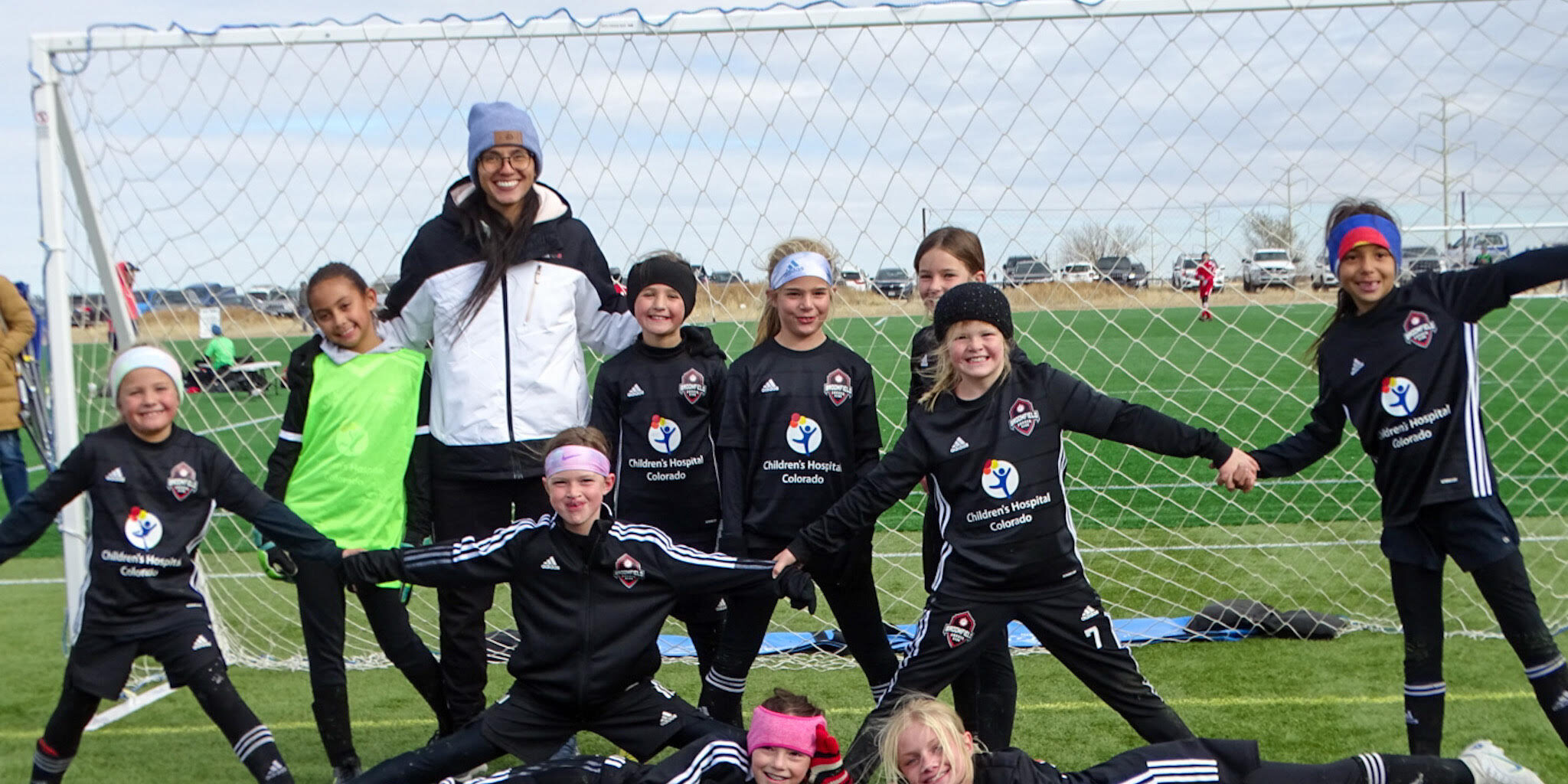 Players posing with coach on camp