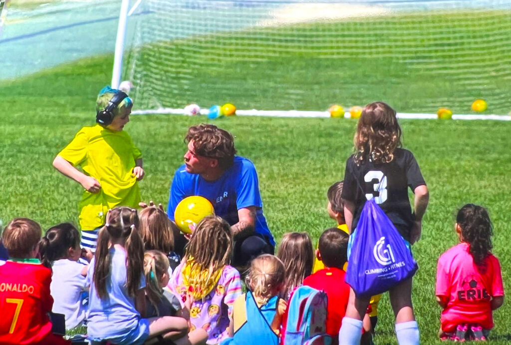 Coach talking with kids at the start of camp