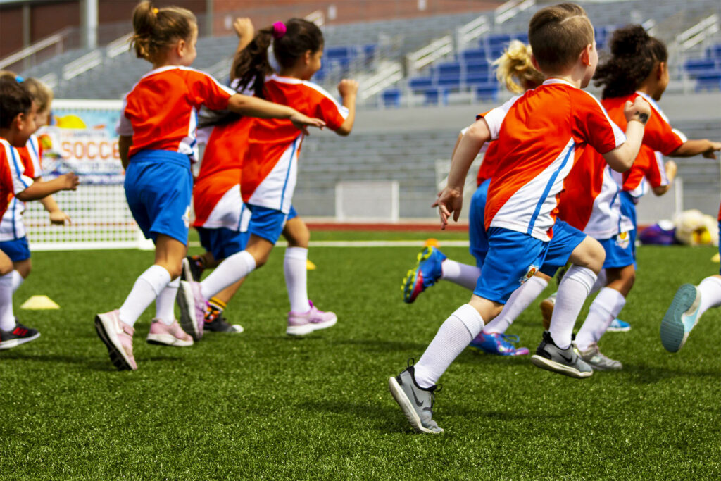 TinyTykes Kids Running on a Soccer Camp