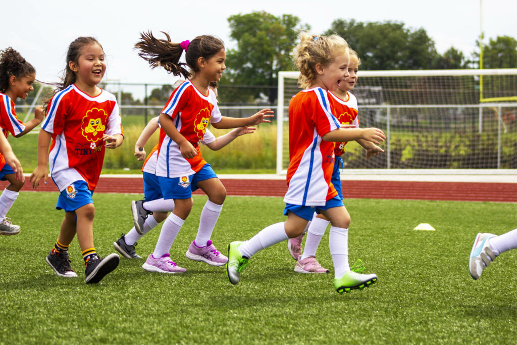 TinyTykes Young Players Running and Having Fun